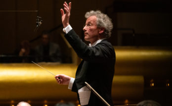 Conductor Franz Welser-Möst performing with an orchestra.