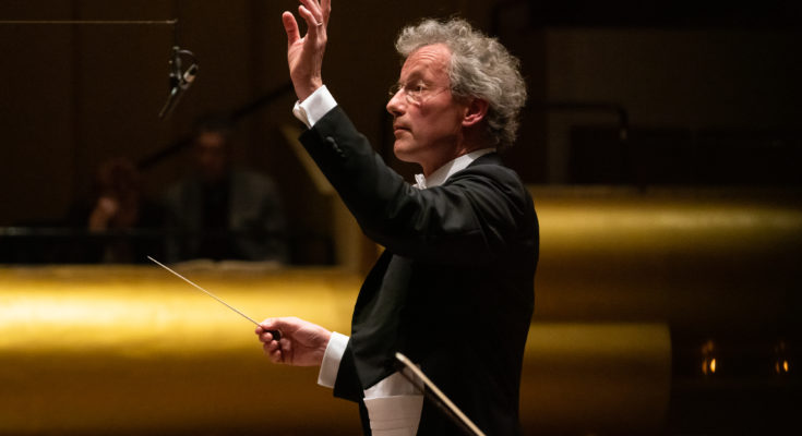 Conductor Franz Welser-Möst performing with an orchestra.