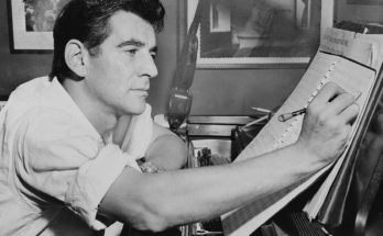 A photo of young Leonard Bernstein composing at a piano.