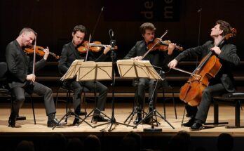 A photo of Quatuor Ébène performing on stage.