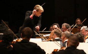 A photo of Marin Alsop conducting an orchestra.