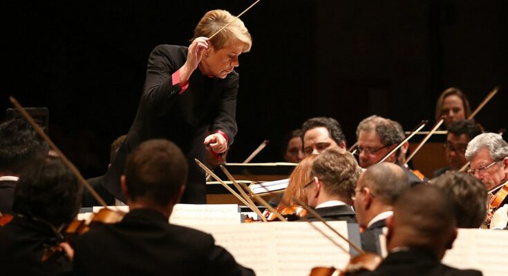 A photo of Marin Alsop conducting an orchestra.