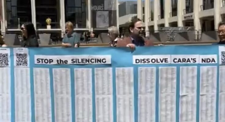 Protesters at New York's Lincoln Center demand the New York Philharmonic dissolve the NDA that silences horn player Cara Kizer from speaking about her alleged sexual assault. Photo: Lara St. John (@stjohnlara) via Instagram